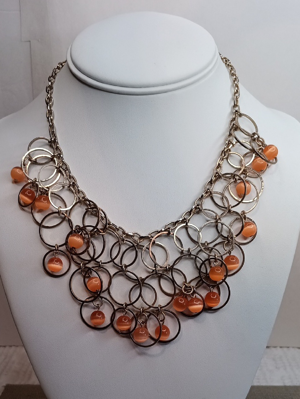 Silver Tone Multi-Ring Necklace with Orange Bead Accents
